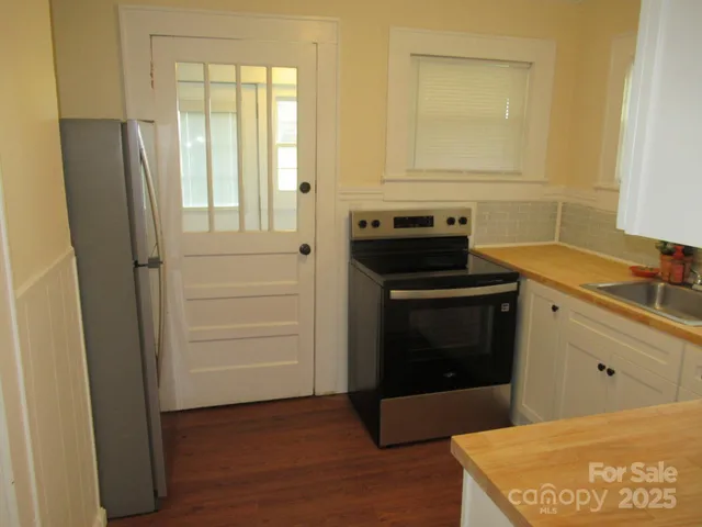 a kitchen with a stove and a refrigerator