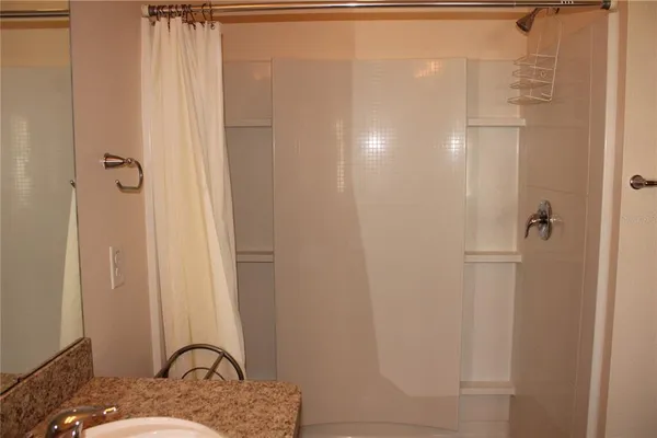 a bathroom with a granite countertop sink
