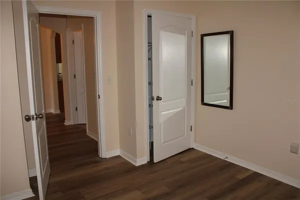 a view of a hallway with wooden floor