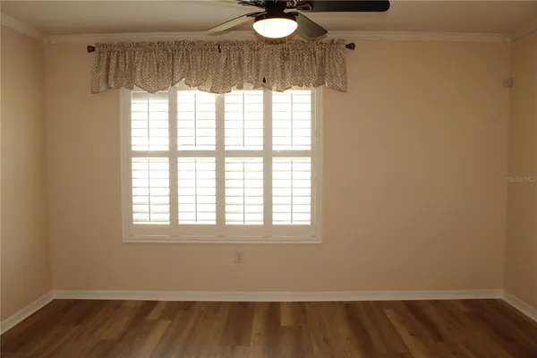 a view of a room with wooden floor and windows