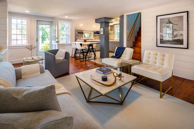 a living room with a bed furniture and a window