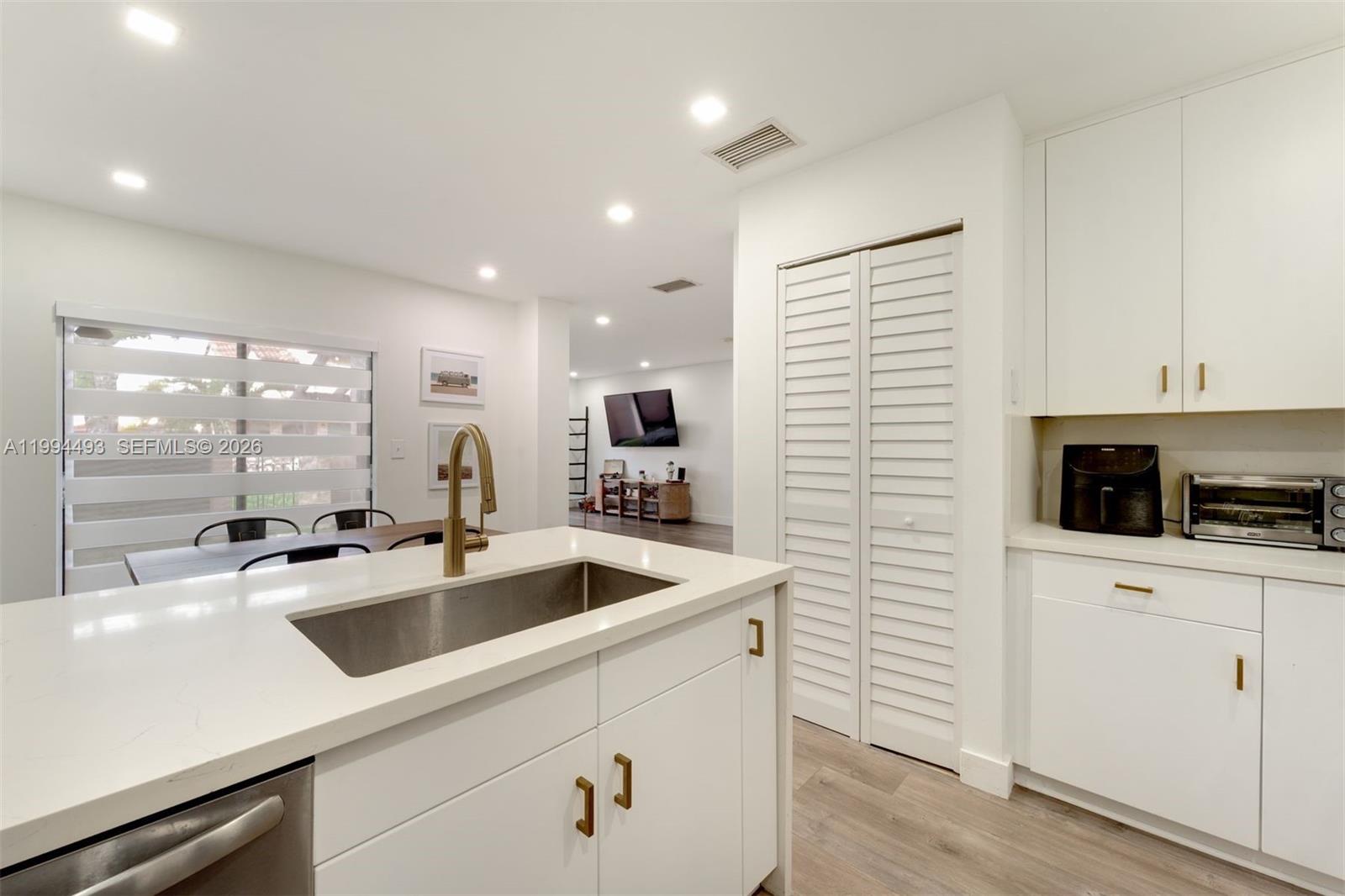 13235 Southwest 114th Terrace Miami, FL 33186 - Photo 13 of 26 a kitchen with a sink and cabinets