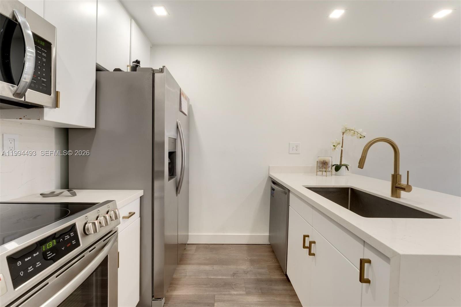 13235 Southwest 114th Terrace Miami, FL 33186 - Photo 15 of 26 a kitchen with stainless steel appliances a sink stove and refrigerator