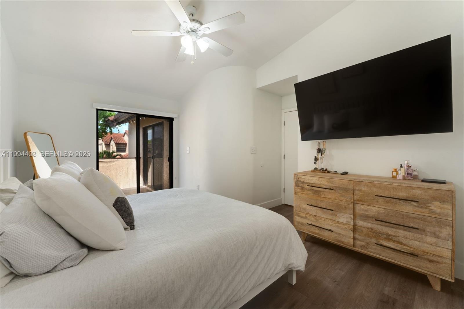13235 Southwest 114th Terrace Miami, FL 33186 - Photo 19 of 26 a bedroom with a bed and a flat screen tv