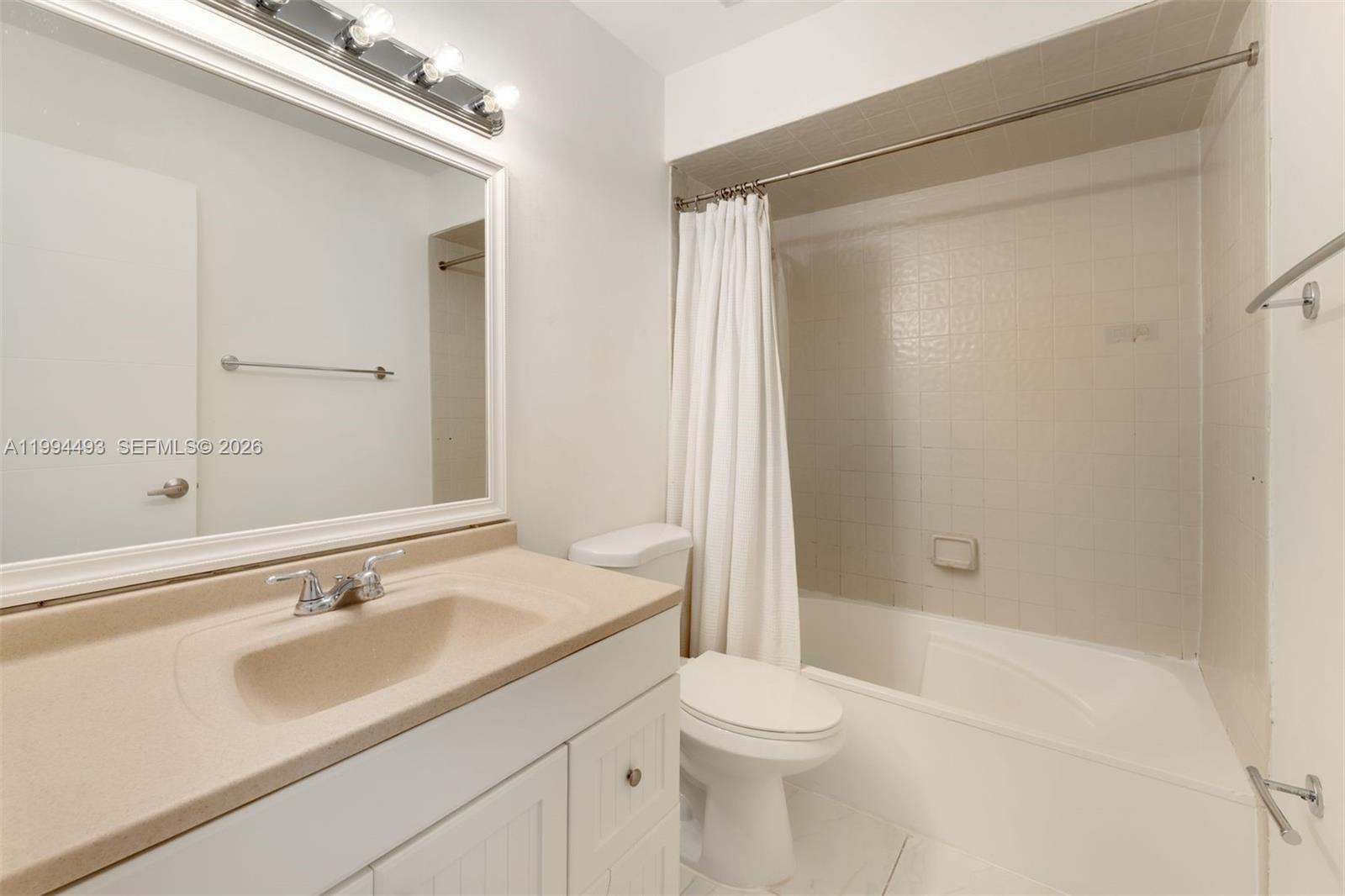 13235 Southwest 114th Terrace Miami, FL 33186 - Photo 22 of 26 a bathroom with a sink a toilet and shower
