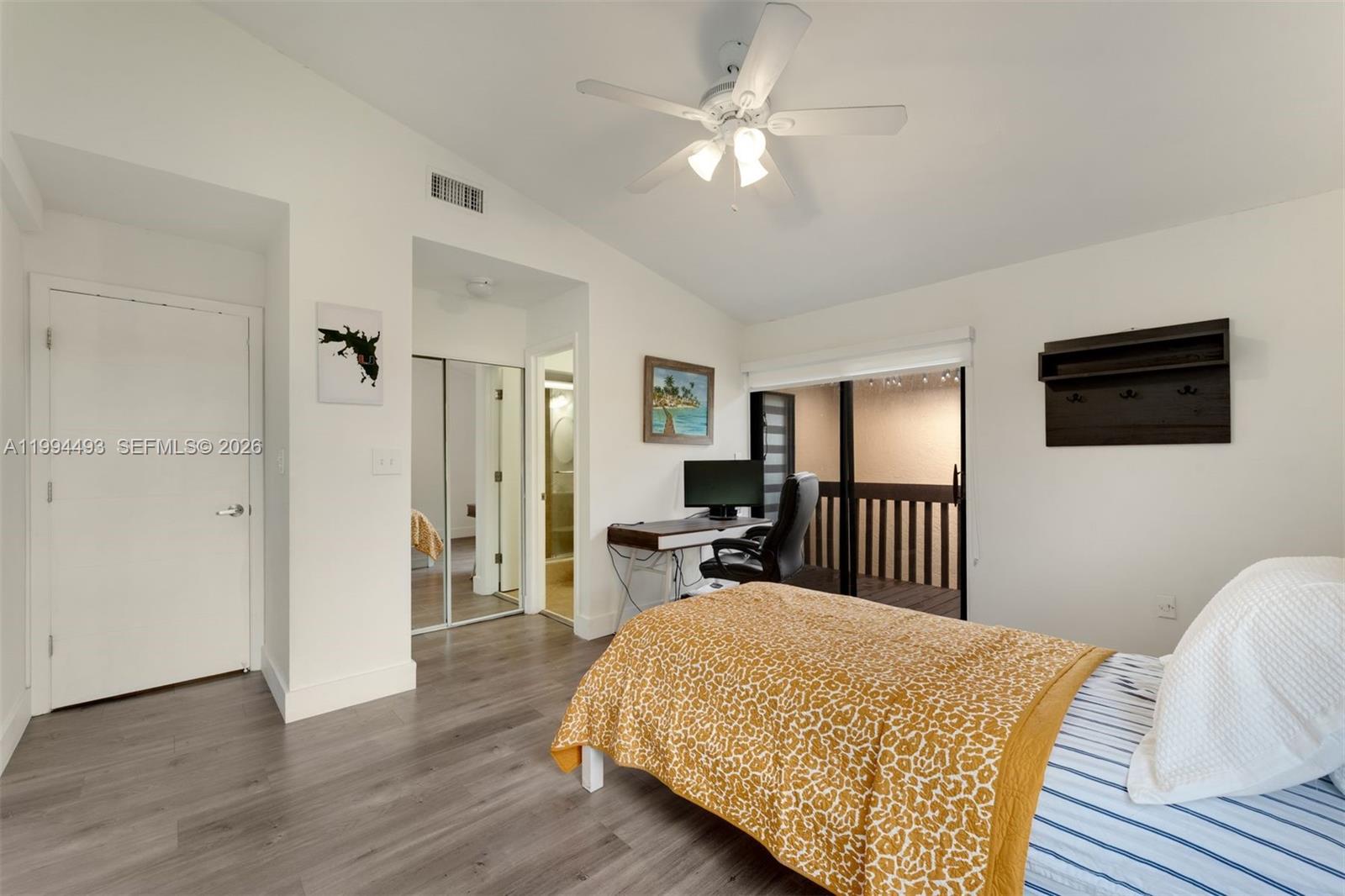 13235 Southwest 114th Terrace Miami, FL 33186 - Photo 23 of 26 a bedroom with a bed and a chandelier