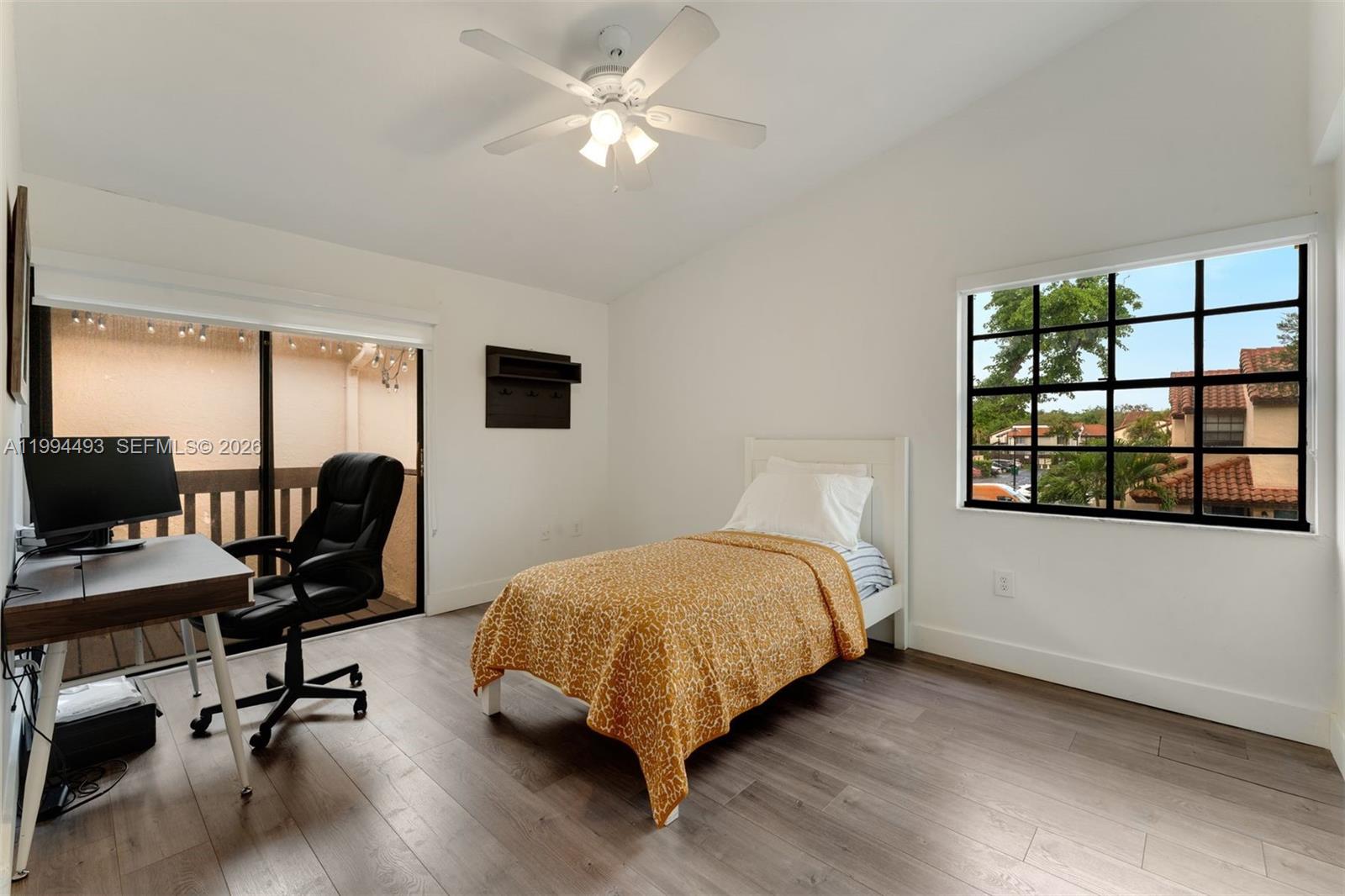 13235 Southwest 114th Terrace Miami, FL 33186 - Photo 24 of 26 a bedroom with a bed and a desk with chair