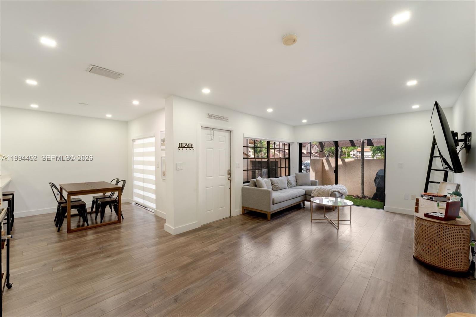 13235 Southwest 114th Terrace Miami, FL 33186 - Photo 4 of 26 a view of a living room and dining room with furniture wooden floor