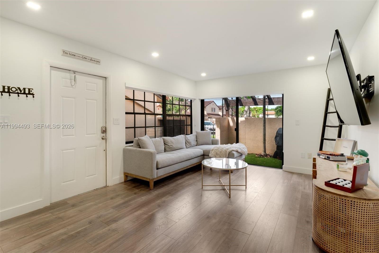 13235 Southwest 114th Terrace Miami, FL 33186 - Photo 5 of 26 a living room with furniture and a flat screen tv