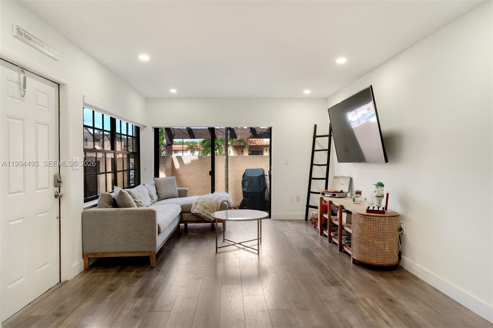 13235 Southwest 114th Terrace Miami, FL 33186 - Photo 6 of 26 a living room with furniture and wooden floor