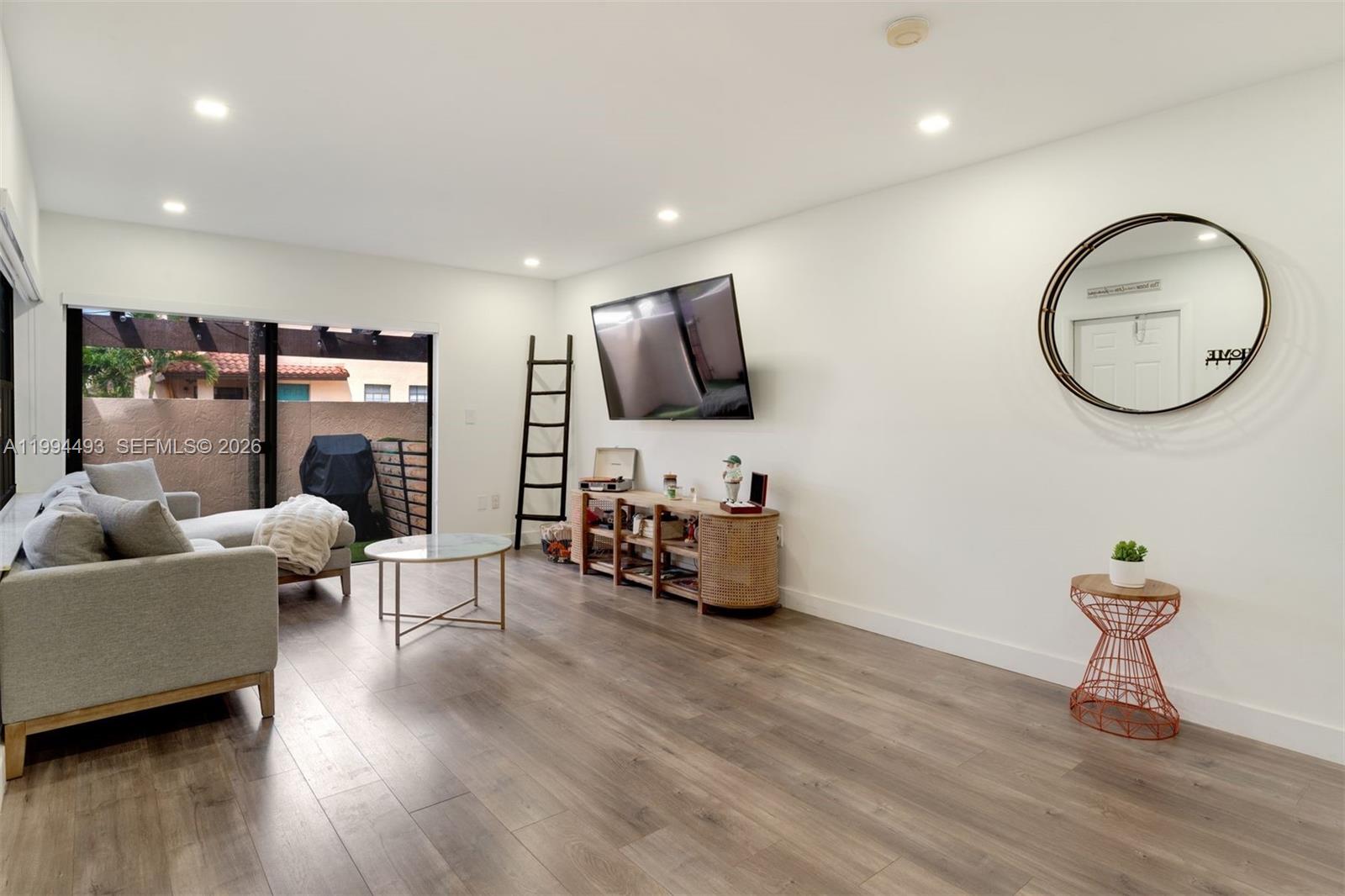 13235 Southwest 114th Terrace Miami, FL 33186 - Photo 7 of 26 a living room with furniture and a flat screen tv