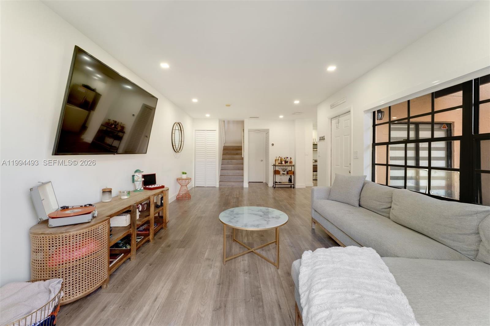 13235 Southwest 114th Terrace Miami, FL 33186 - Photo 8 of 26 a living room with furniture and a flat screen tv