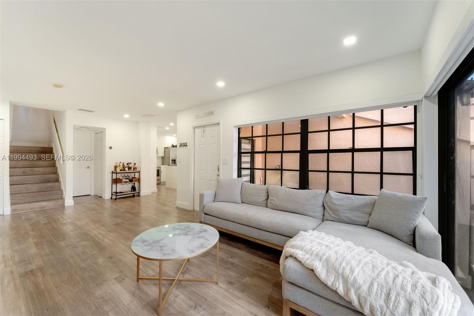 13235 Southwest 114th Terrace Miami, FL 33186 - Photo 9 of 26 a living room with furniture and a large window