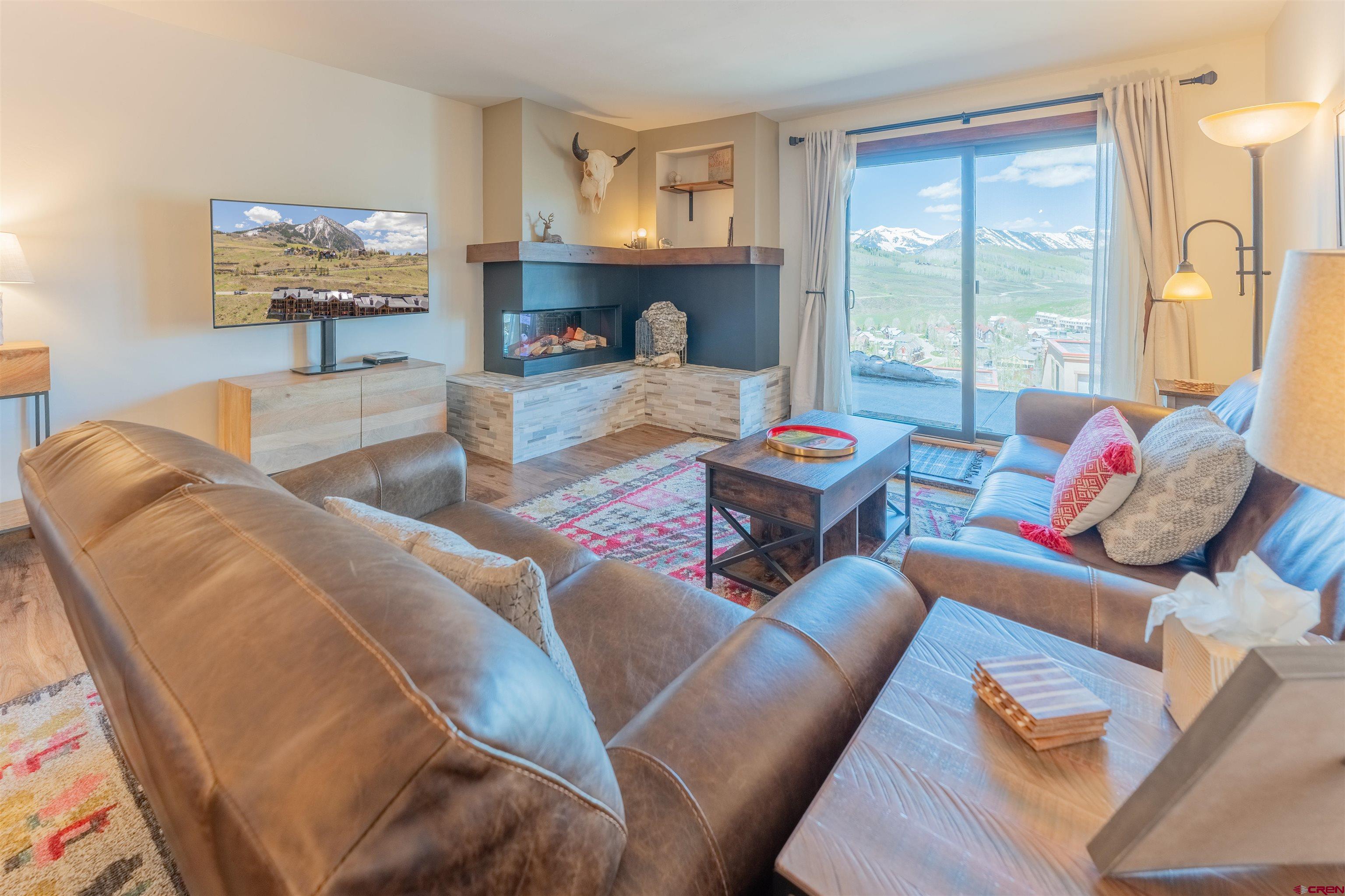72 Hunter Hill Road, Unit I103 Crested Butte, CO 81225 - Photo 15 of 35 a living room with furniture and a large window