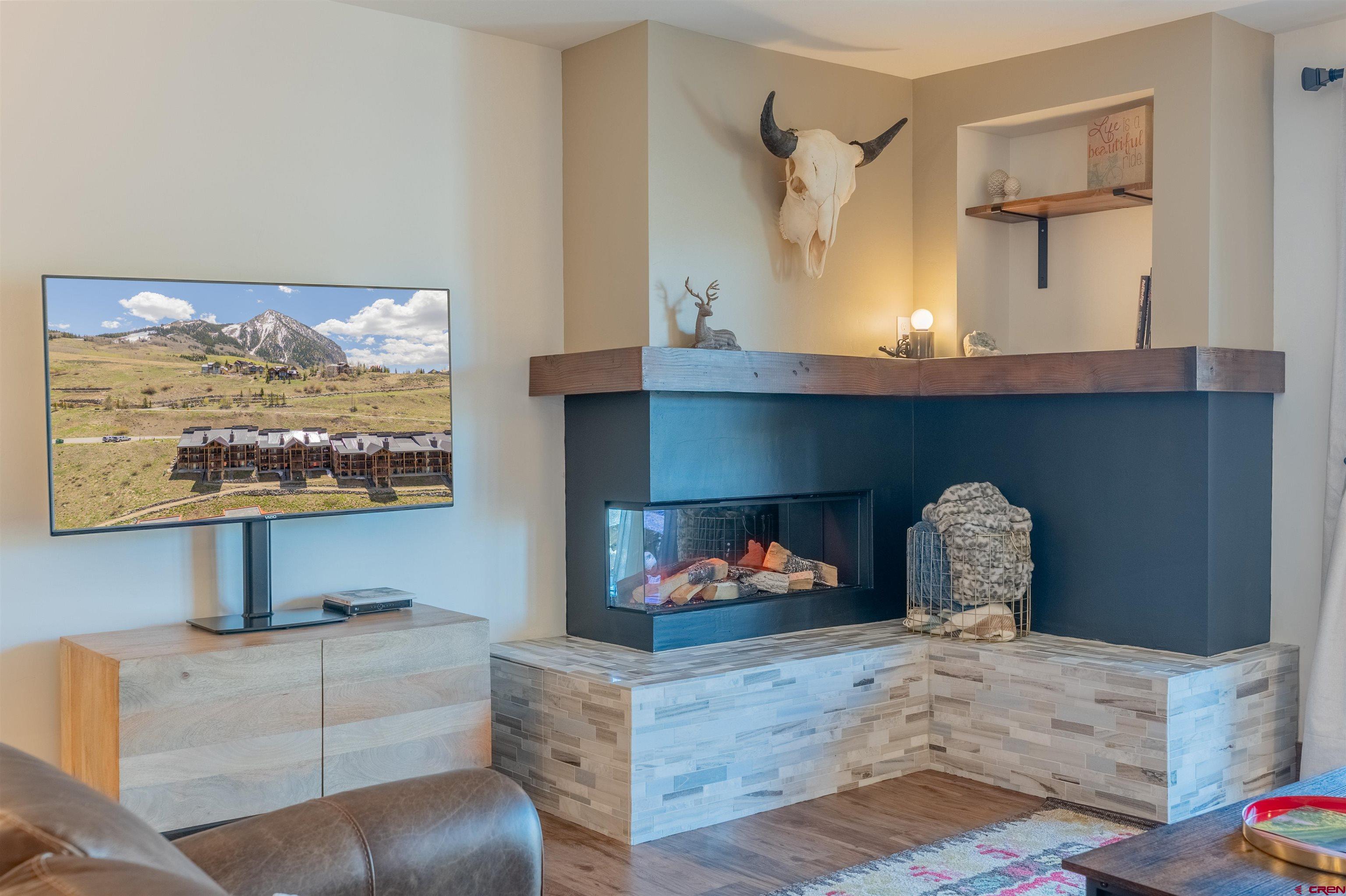 72 Hunter Hill Road, Unit I103 Crested Butte, CO 81225 - Photo 16 of 35 a living room with furniture and a fireplace