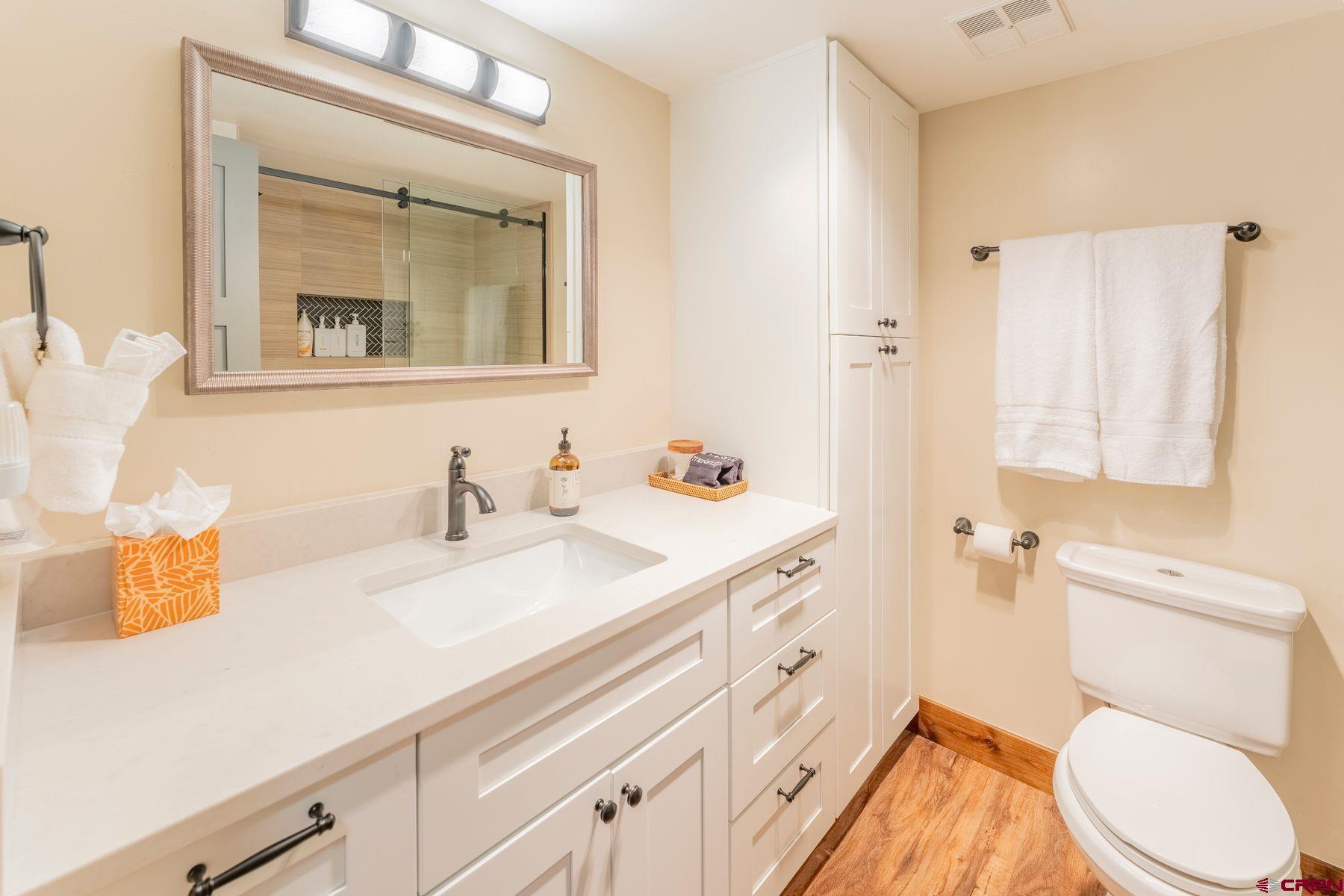 72 Hunter Hill Road, Unit I103 Crested Butte, CO 81225 - Photo 25 of 35 a bathroom with a sink vanity granite and toilet