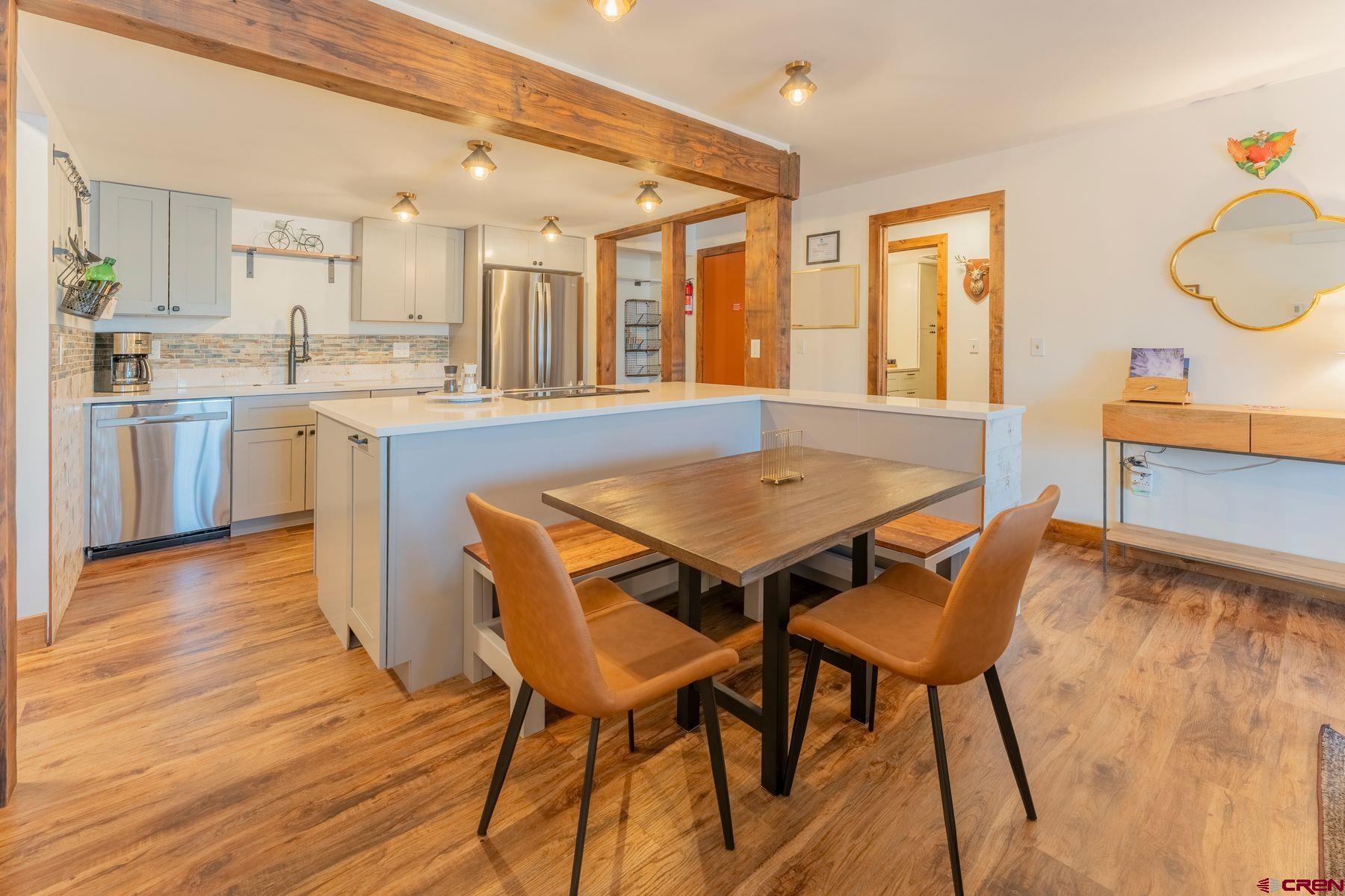 72 Hunter Hill Road, Unit I103 Crested Butte, CO 81225 - Photo 5 of 35 a open kitchen with a table and chairs in it