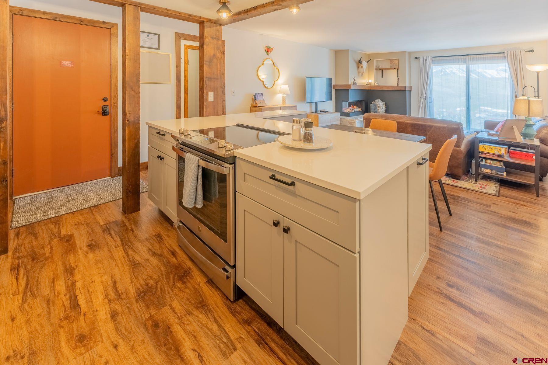 72 Hunter Hill Road, Unit I103 Crested Butte, CO 81225 - Photo 6 of 35 a kitchen with a stove a sink and a refrigerator