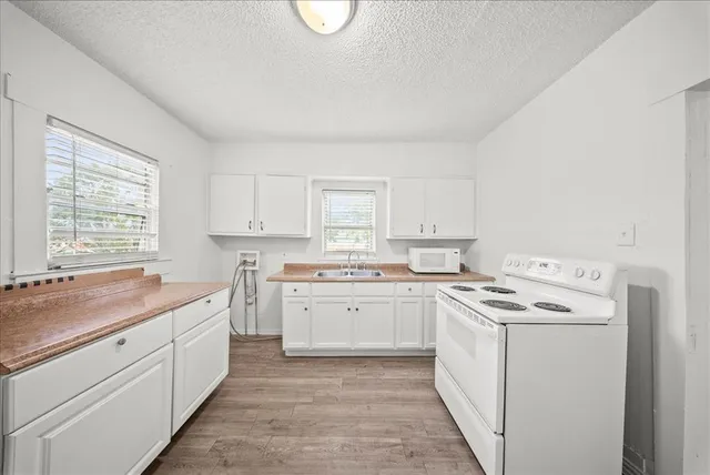 a kitchen that has a sink and a stove