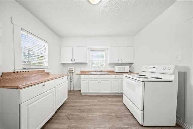 a kitchen with cabinets appliances and a counter space