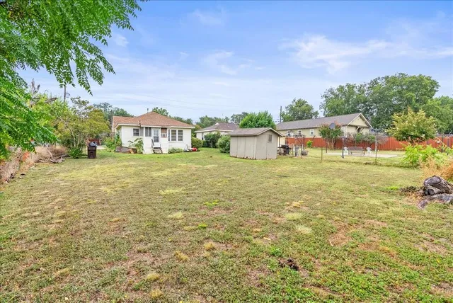 a view of a house with yard and lake view
