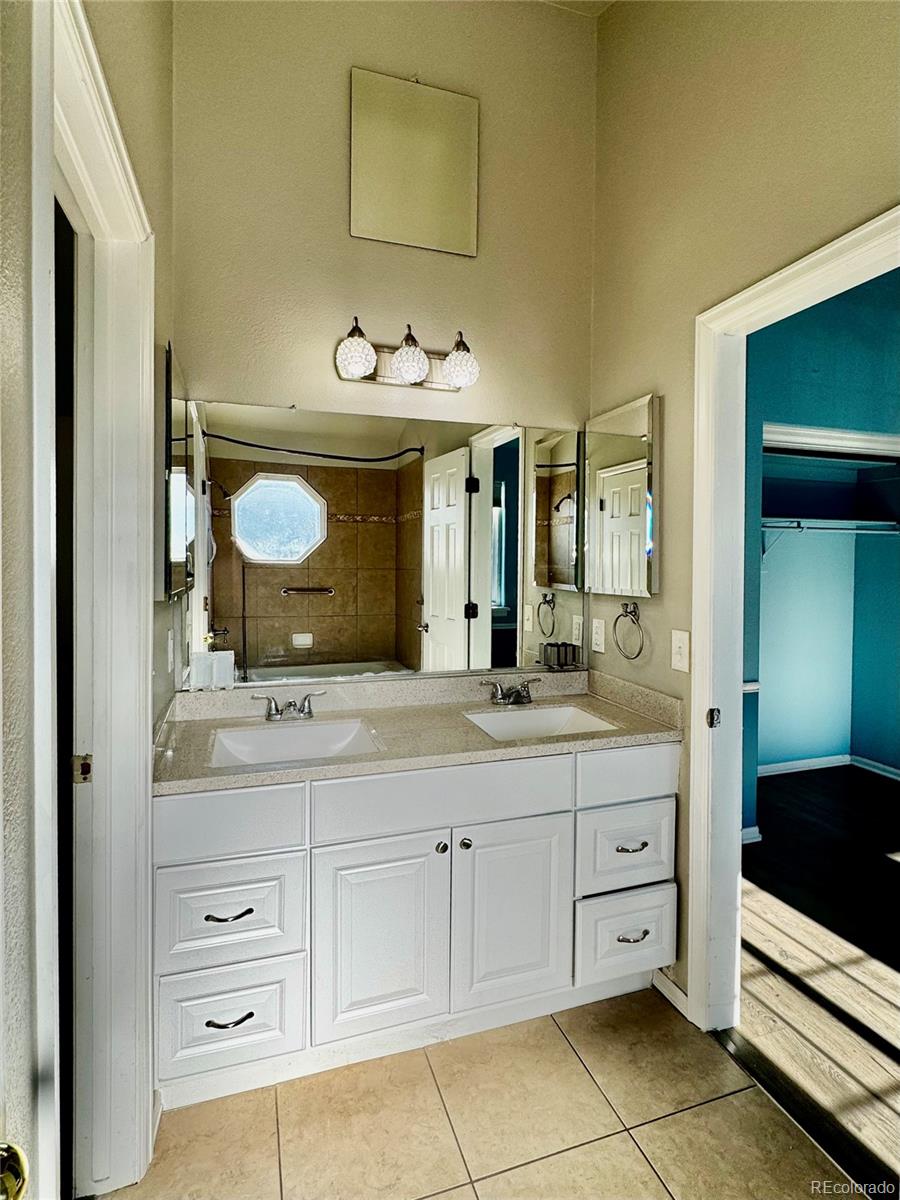 3615 South Flanders Street Aurora, CO 80013 - Photo 15 of 30 a bathroom with a sink and a mirror