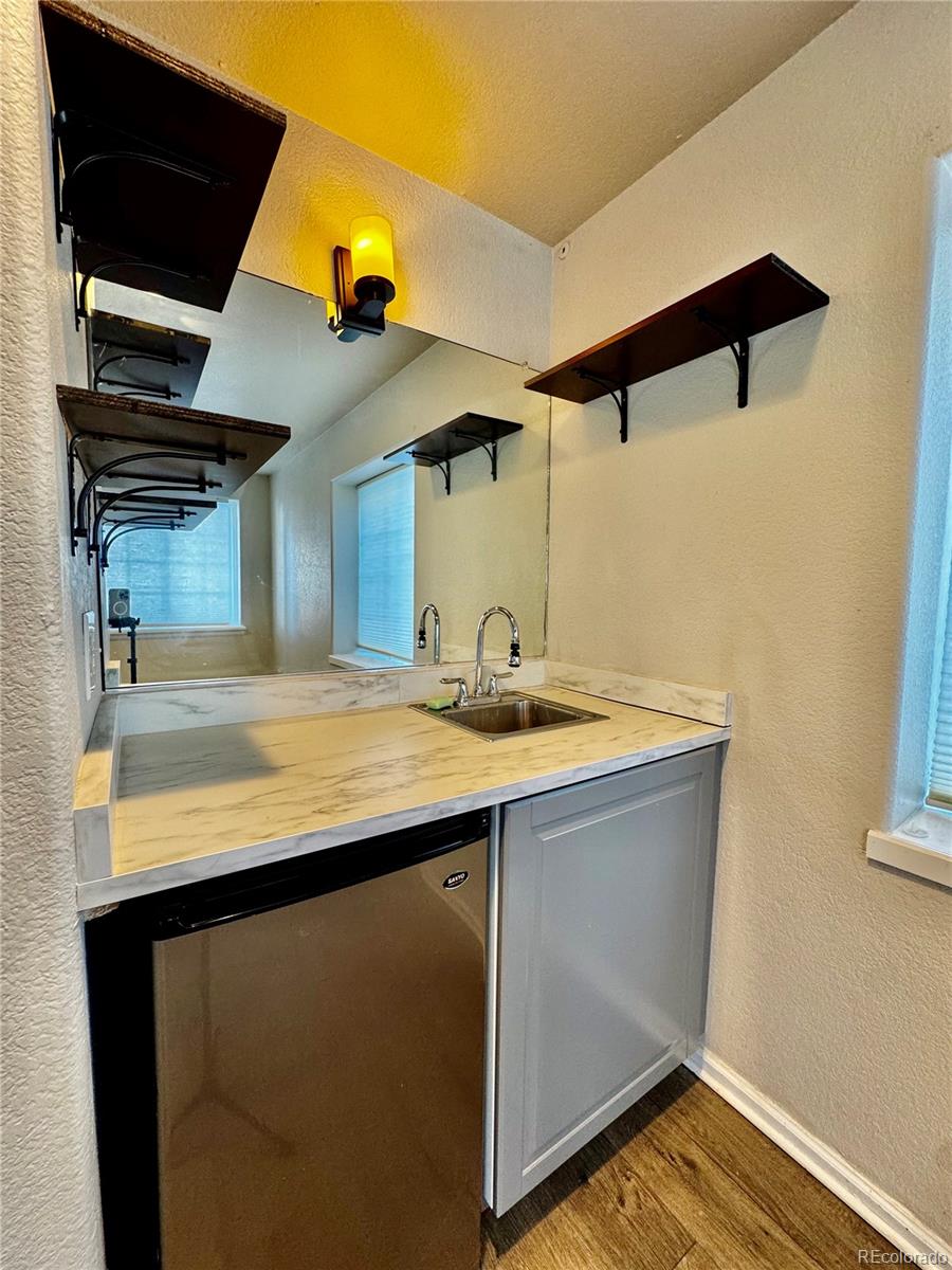 3615 South Flanders Street Aurora, CO 80013 - Photo 18 of 30 a kitchen with a sink and a refrigerator