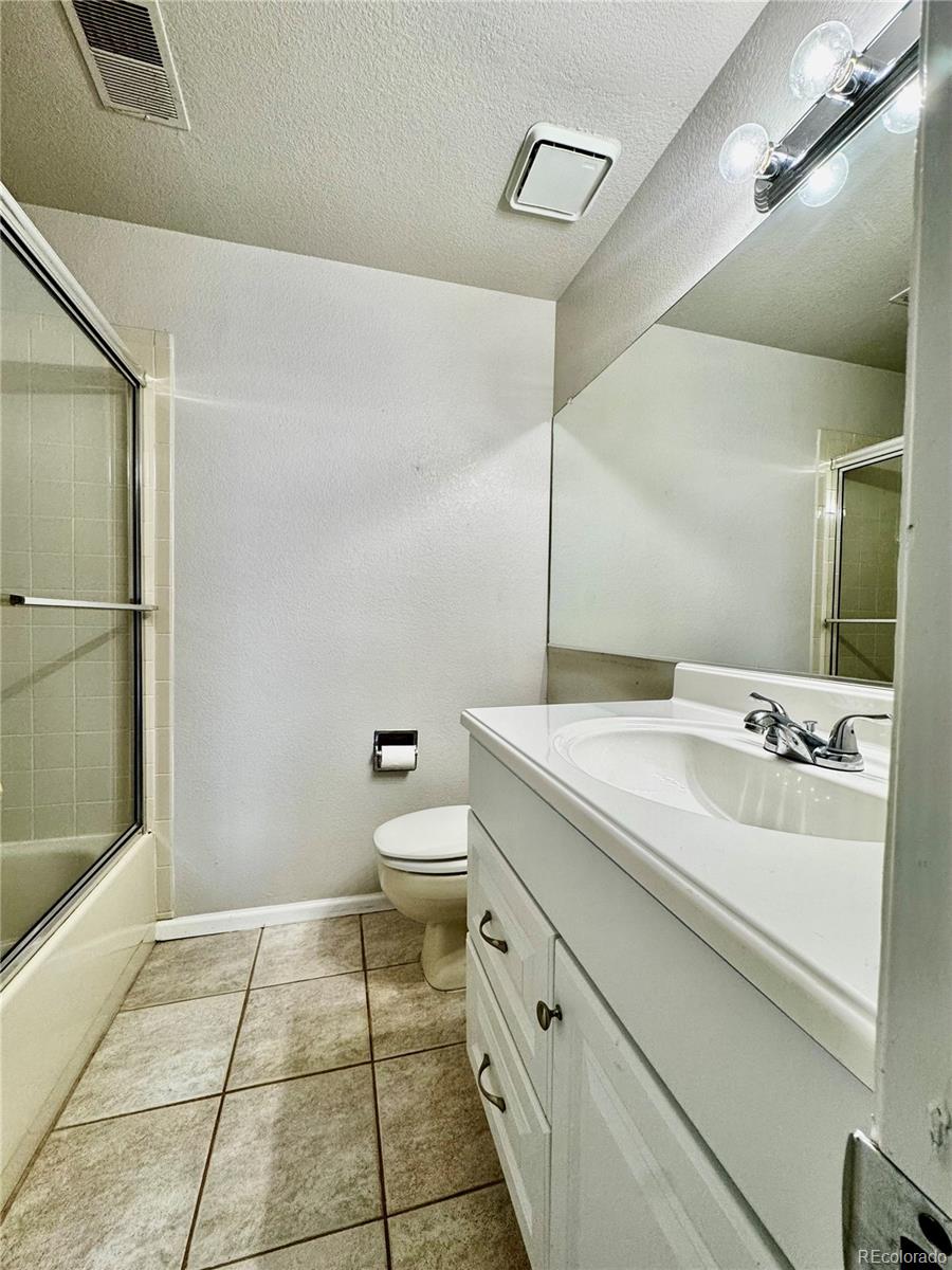 3615 South Flanders Street Aurora, CO 80013 - Photo 19 of 30 a bathroom with a sink a toilet and a mirror