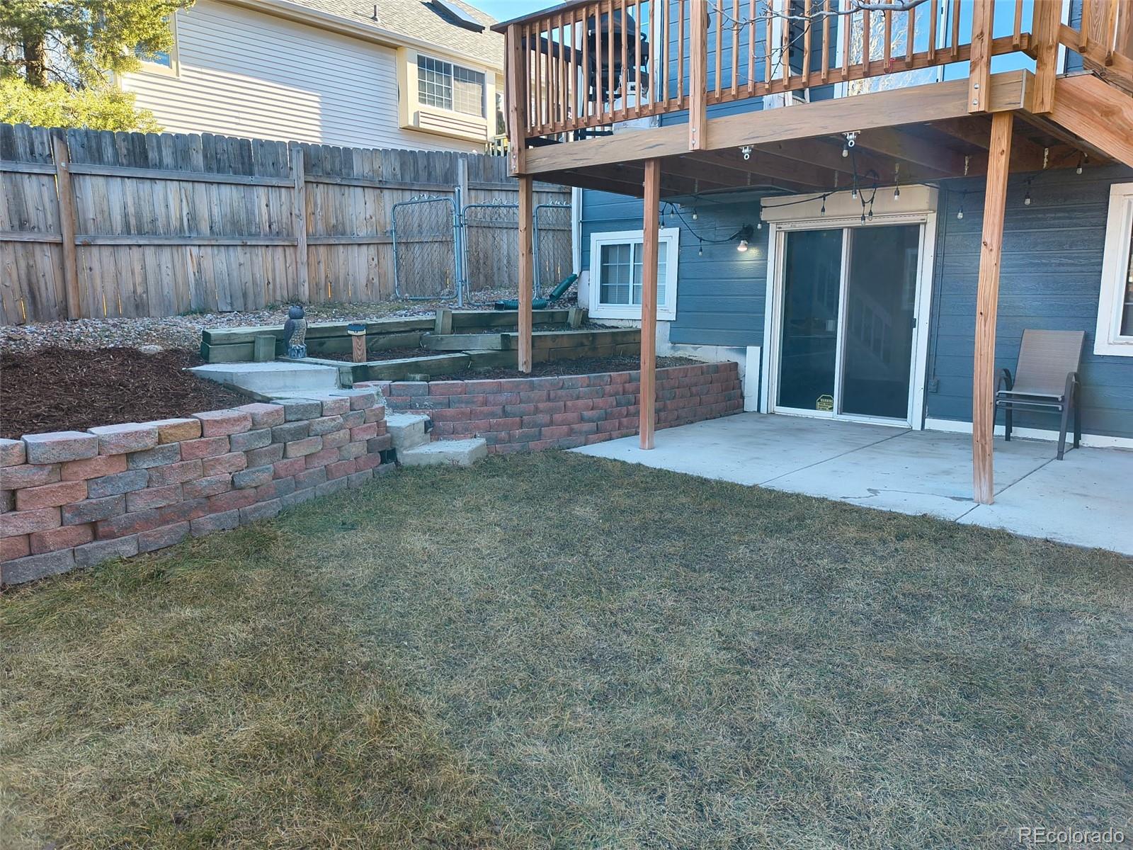 3615 South Flanders Street Aurora, CO 80013 - Photo 22 of 30 a view of a chair and table in backyard of the house