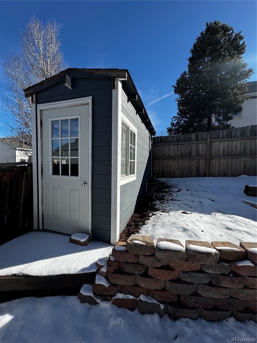 3615 South Flanders Street Aurora, CO 80013 - Photo 27 of 30 a front view of a house with a yard