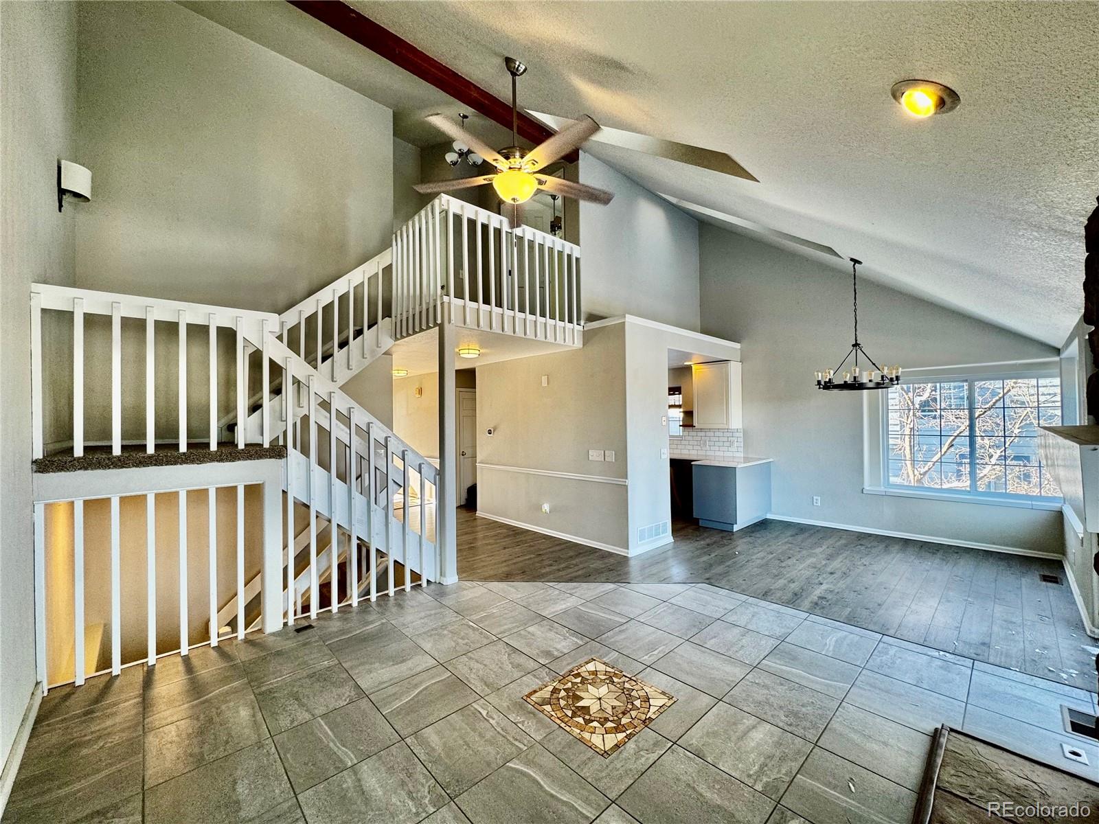 3615 South Flanders Street Aurora, CO 80013 - Photo 4 of 30 a view of staircase with white walls and windows
