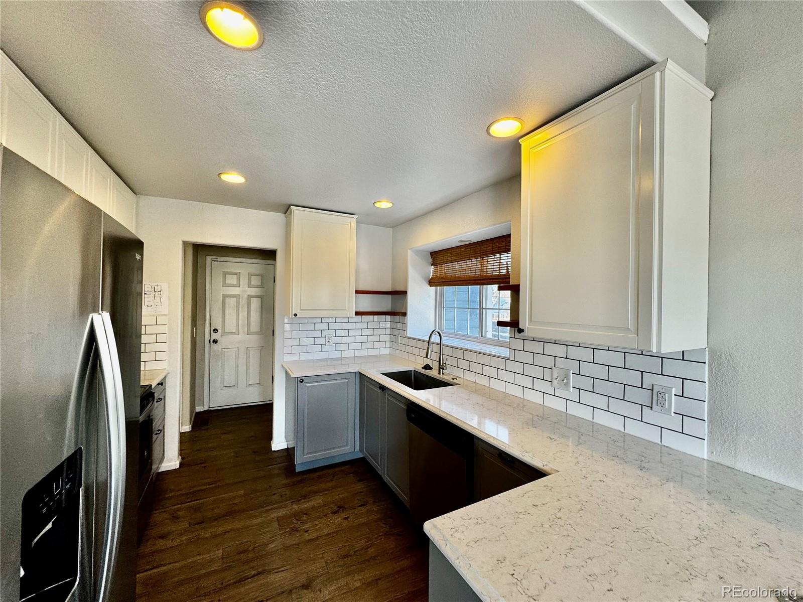 3615 South Flanders Street Aurora, CO 80013 - Photo 7 of 30 a kitchen with stainless steel appliances granite countertop a sink stove and refrigerator