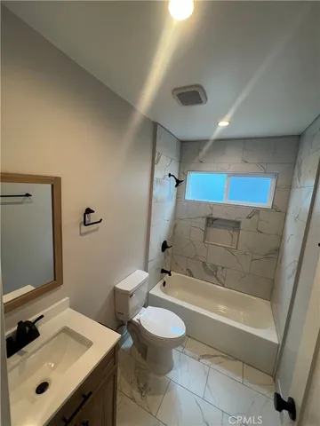 a bathroom with a bathtub sink and toilet