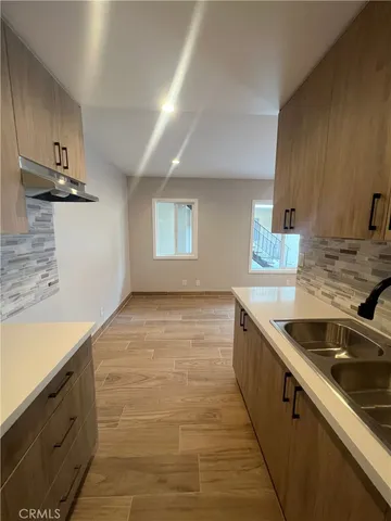 a kitchen with granite countertop a sink and a stove