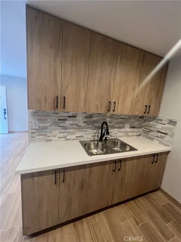 a kitchen with kitchen island sink refrigerator and cabinets