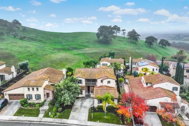 an aerial view of residential houses with outdoor space and street view