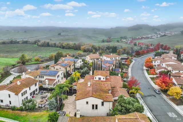 an aerial view of residential houses with outdoor space and street view