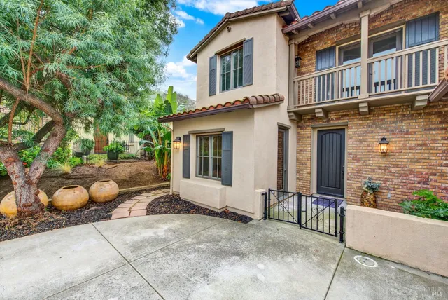 a view of a house with a backyard and a large tree