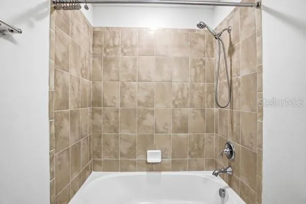 a bathroom with a sink a toilet a mirror a bathtub and shower