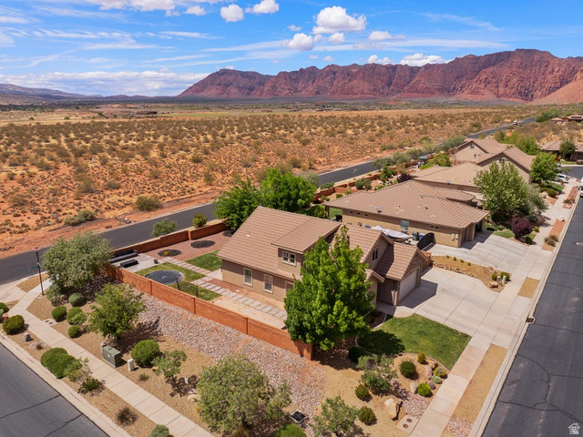 225 Falcon Court Ivins, UT 84738 - Photo 38 of 47 Aerial perspective of suburban area with mountains and a desert landscape