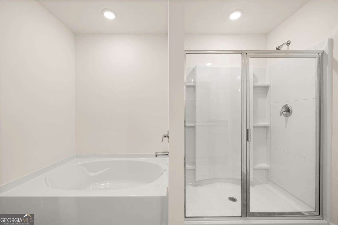 6010 Knickerbocker Street, Unit 135 Mableton, GA 30126 - Photo 7 of 17 a bathroom with a shower and a bath tub