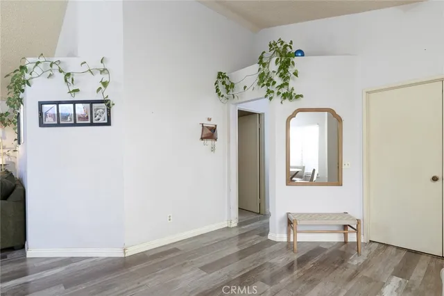 a view of a bedroom with wooden floor and hallway