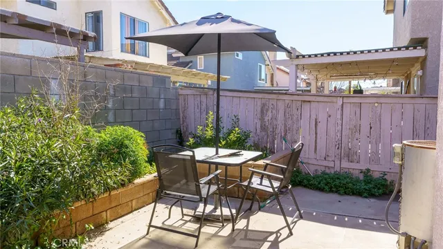a view of a table and chairs under an umbrella in the patio