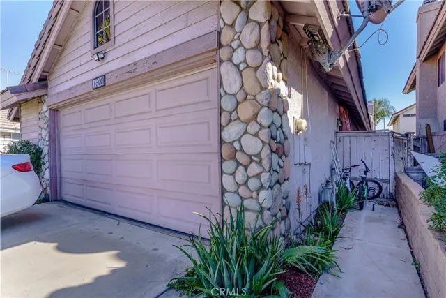 a couple of potted plants in front of door