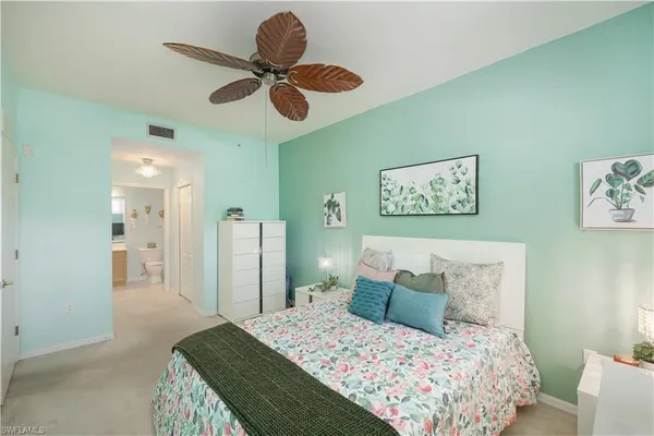 a bedroom with a bed and a lamp