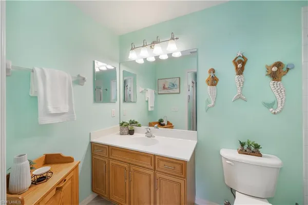a white toilet sitting next to a bathroom sink
