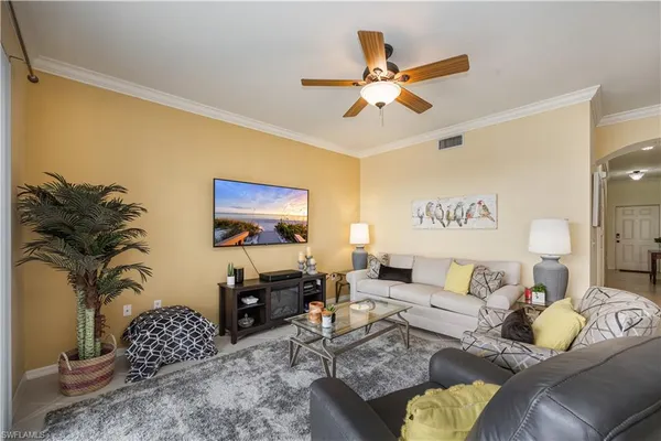 a living room with furniture and a chandelier