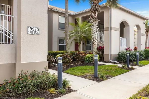 a view of a house with potted plants