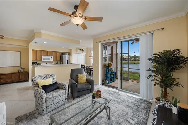 a living room with furniture and a floor to ceiling window