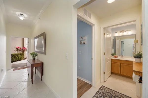 a large white kitchen with a large window and stainless steel appliances